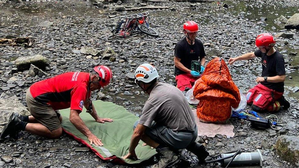 Rescuers prepare equipment prior to airlifting the casualty to safety