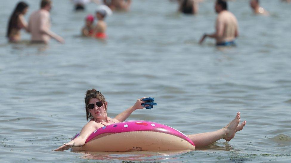 People enjoy the hot weather at Southend beach in Essex. 8 August 2020