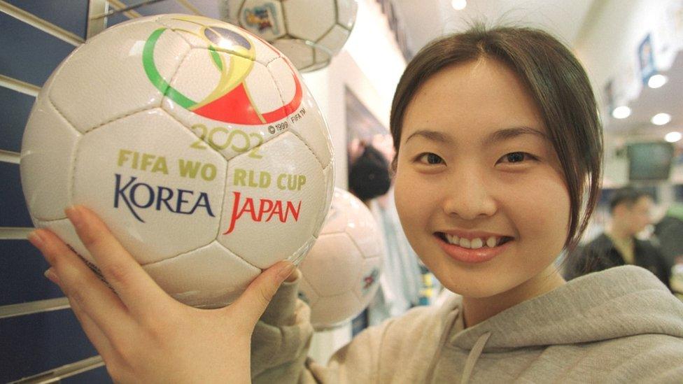 A South Korean girl holds a Fevernova, the official ball of the 2002 World Cup jointly hosted by South Korea and Japan