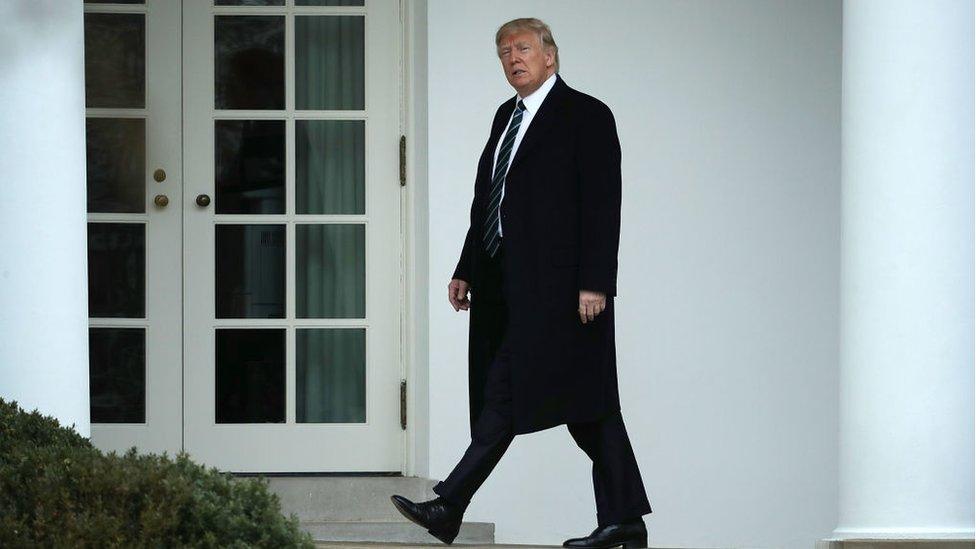 President Donald Trump walks along the West Wing colonnade before departing the White House.