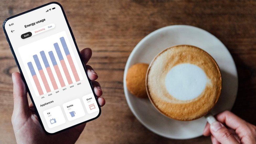 Phone with energy usage alongside cup of coffee