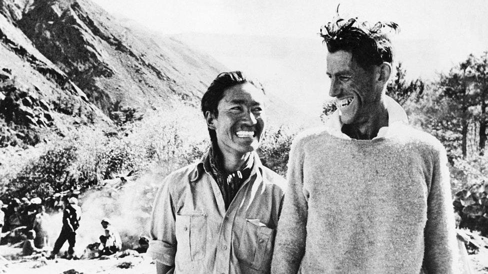 Smiling victors Sherpa Tenzing (Left) and Edmund Hillary at their camp after their return from Everest.