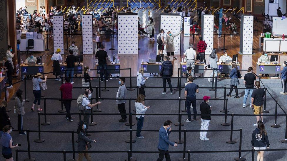 A queue of people wait to get vaccinated at a hall in Melbourne