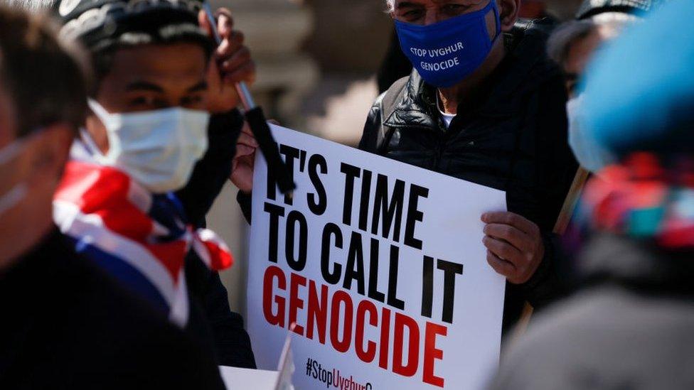 Members of the Uighur community and human rights activists demonstrate outside the Houses of Parliament in London, United Kingdom on April 22, 2021.