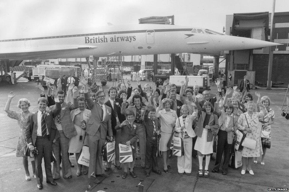 Thirty-five winners wave good-bye before departing from Heathrow Airport, London, on Concorde's first public passenger flight, 25 August 1975