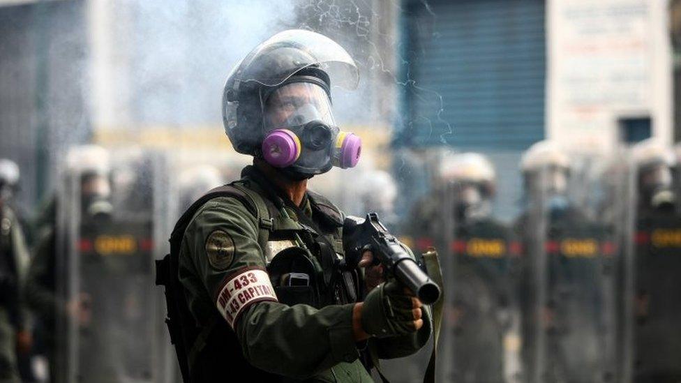 Members of the Bolivarian National Guard (GNB) block the passage to a demonstration against the government of President Nicolas Maduro in Caracas, Venezuela, 26 April 2017.