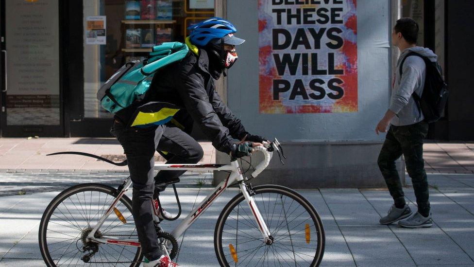 Person cycling through Cardiff City Centre