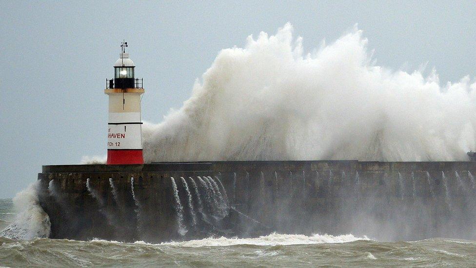 Waves crash against Newhaven Lighthouse in southern England on December 30, 2015, as "Storm Frank" sweeps across Britain