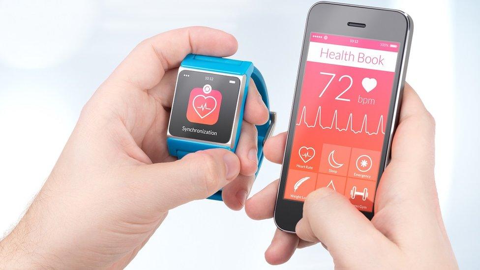 Smartphone and smartwatch showing heart monitor data