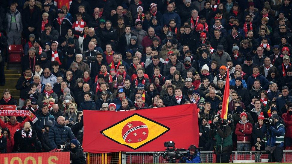 Liverpool fans in the UK hold a Brazil-inspired flag