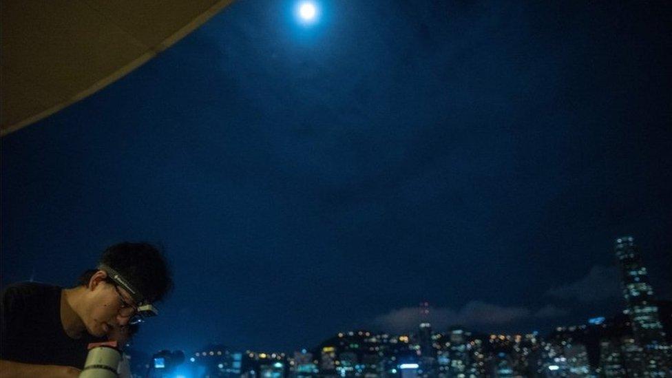 People set up the telescopes to observe the Lunar eclipse in Tsim Sha Tsui in Hong Kong on July 28, 2018.