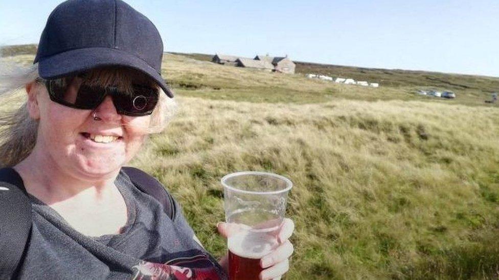 Wendy Clarke with a pint outside