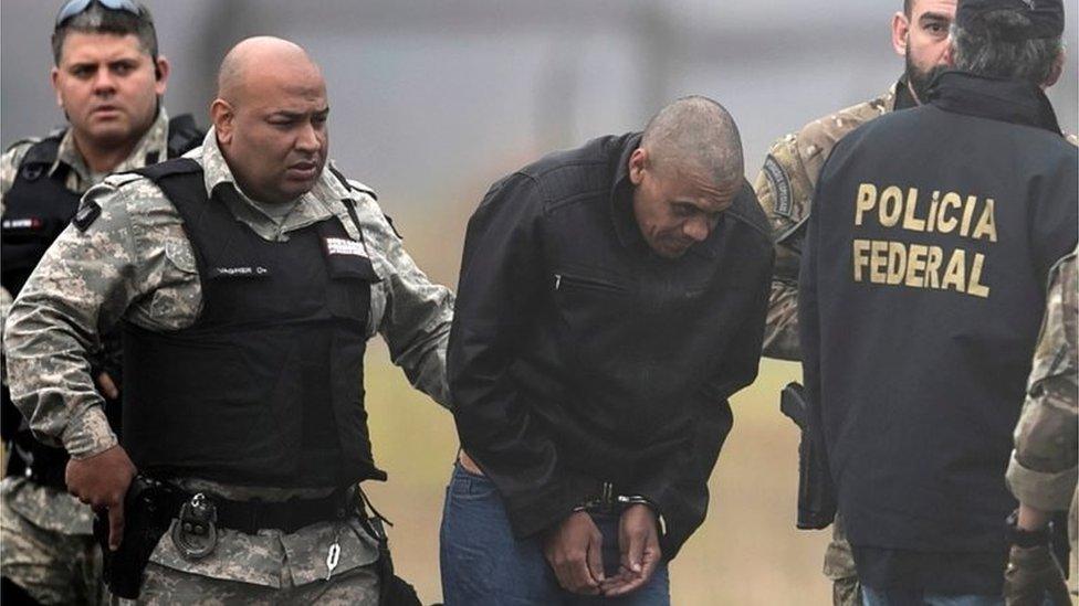 Federal Police agents escort Adelio Bispo de Oliveira, suspected of stabbing Brazilian presidential candidate Jair Bolsonaro, to transfer him to a federal prison in Campo Grande, Mato Grosso state, at Francisco Alvares de Assis airport in Juiz de Fora, Brazil, September 8, 2018.