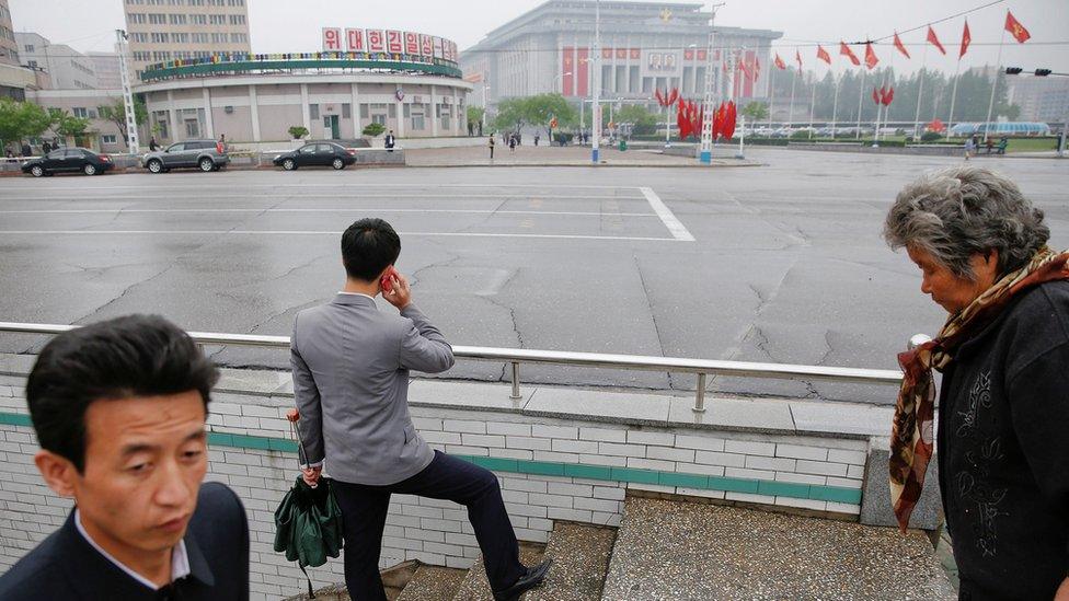 People walk near the venue of a ruling party congress in Pyongyang, North Korea on 6 May, 2016