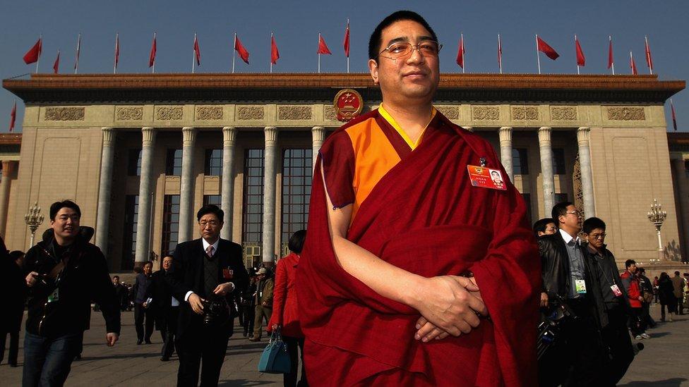 A living buddha of Tibet stands outside the Great Hall of the People in China's capital Beijing