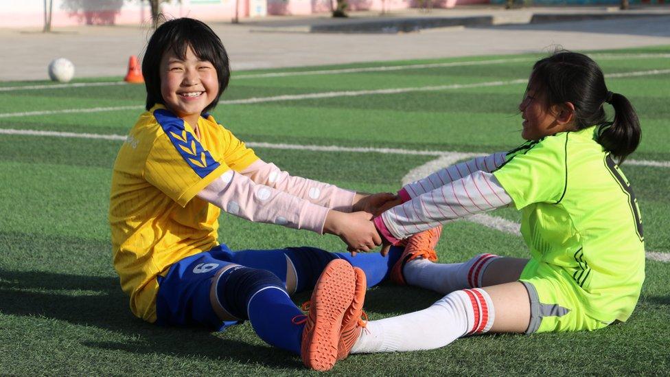 Wang Chun stretching on the football field