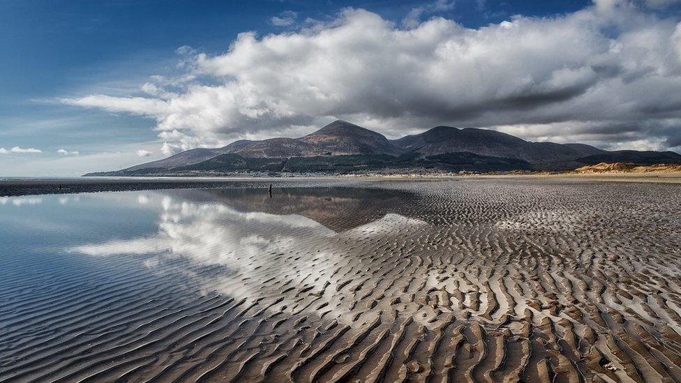 The Mourne Mountains with the 6 main peaks shown here including Slieve Donard the highest at 849 metres. This is the beach at Murlough as accessed from the National Trust car park and the National Nature Reserve