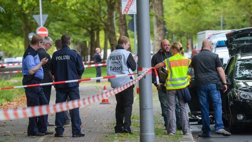 Police investigators secure the scene where officers shot dead an Islamist knifeman