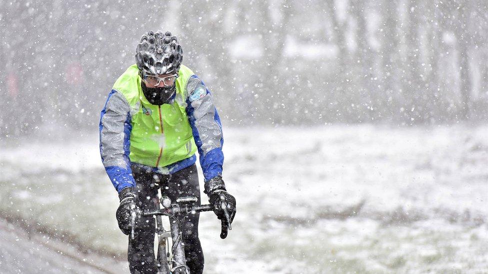 Greg James cycling in the snow