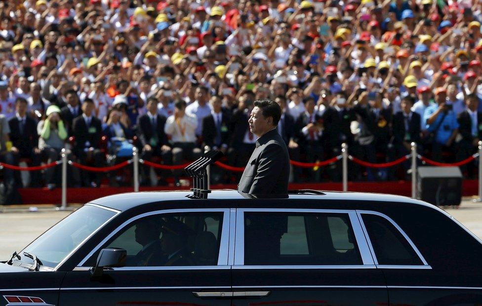 Chinese President Xi Jinping stands in a car on his way to review the army, at the beginning of the military parade marking the 70th anniversary of the end of World War Two, in Beijing, China, 3 September 2015