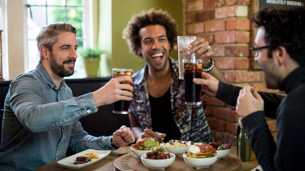 Friends raising a glass at Harvester