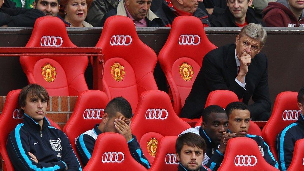 Arsene Wenger watches a match from the sidelines