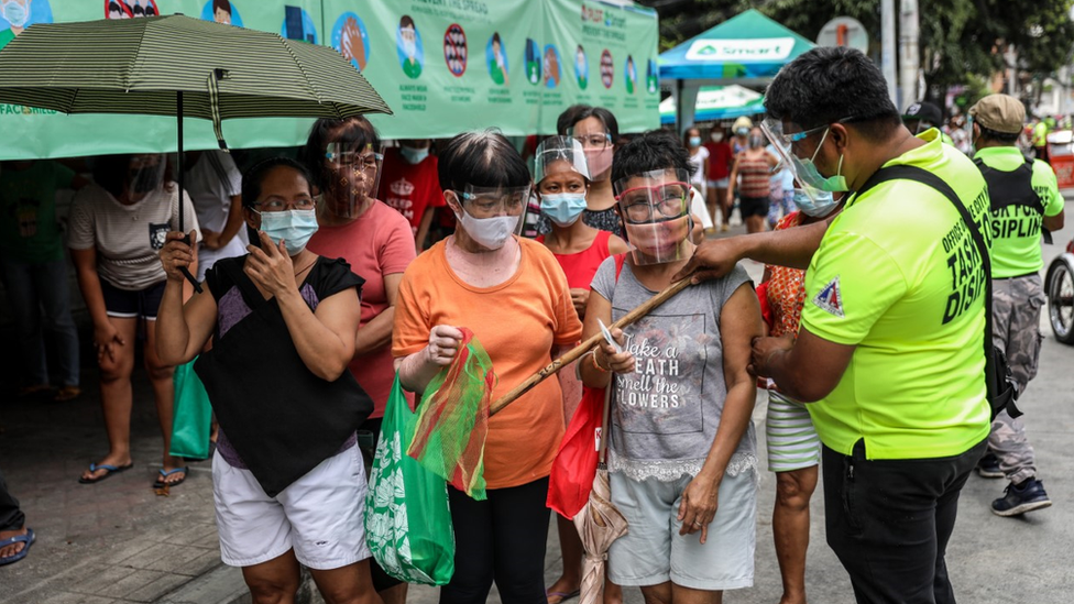 People queuing for free food in Manila