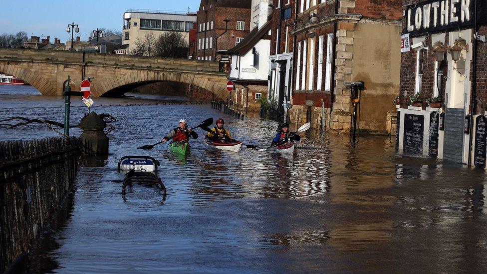 Canoeists check out buildings in flooded York