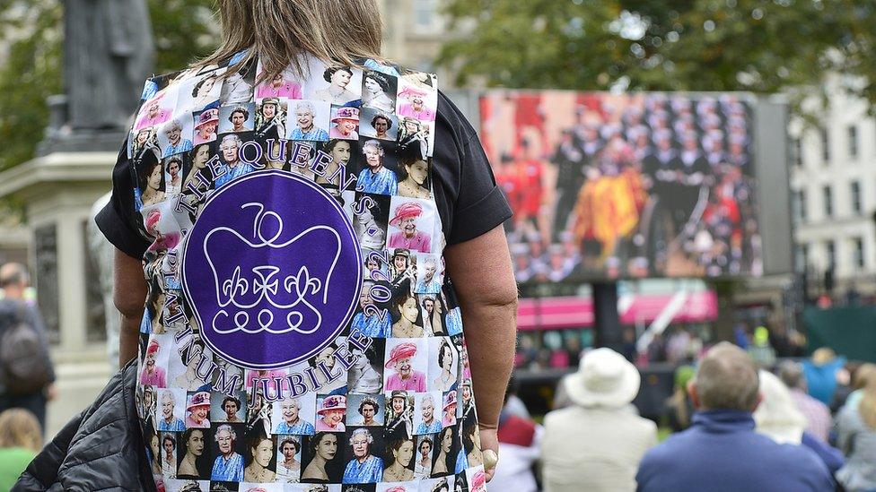 A woman stands in the grounds of Belfast City Hall wearing a Queen waistcoat