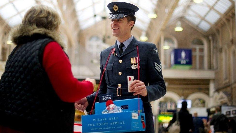 Member of the armed forces sell poppies