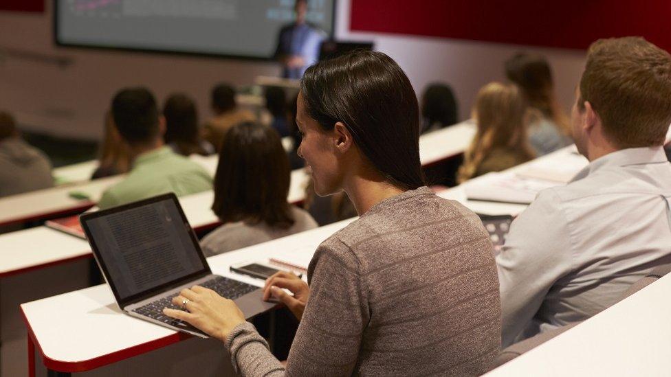 Woman student in lecture theatre