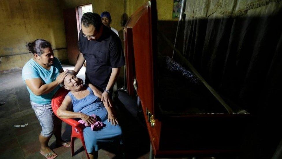 An elderly woman mourns next to a coffin after a relative was shot dead during protests in Leon, Nicaragua, on July 5, 2018