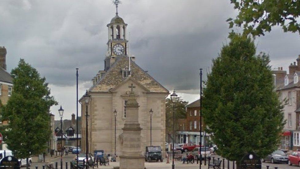 Market square with town hall ahead and trees to either side