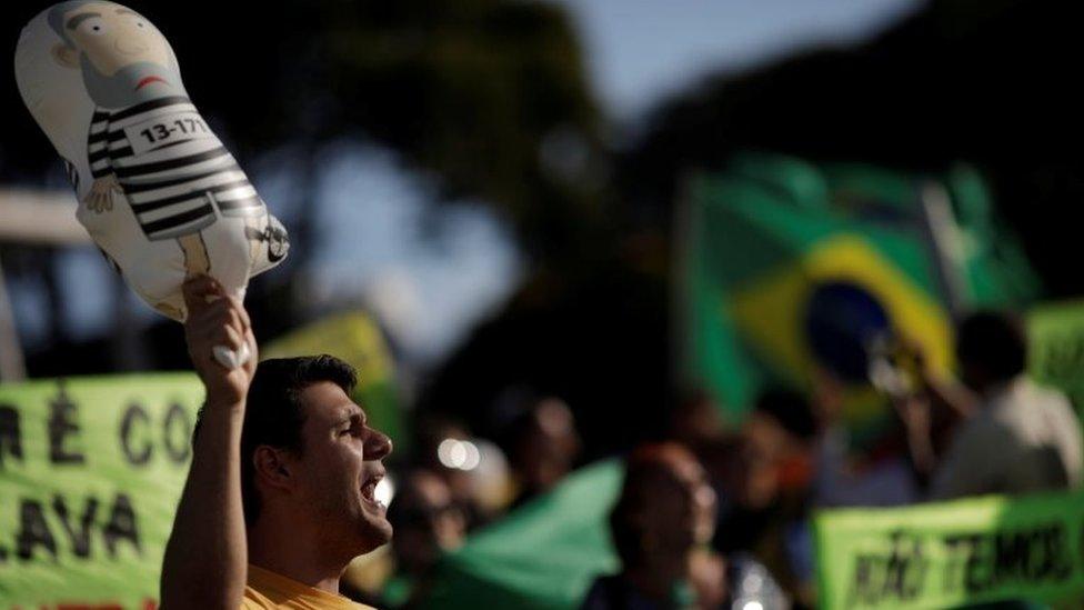 People protest against former Brazilian President Luiz Inacio Lula da Silva, before a Brazilian court decides on an appeal by Lula da Silva against a corruption conviction that could bar him from running in the 2018 presidential race, in Brasilia, Brazil, January 23, 2018