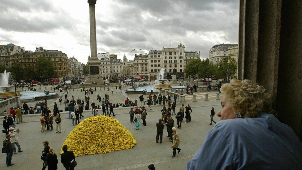 : A woman looks out at the crowd around a large heap of bananas which has been dumped as part of an art exhibition 05 October, 2004 in Trafalgar Square, London 5th October 2004. AFP PHOTO/CARL DE SOUZA (Photo credit should read CARL DE SOUZA/AFP via Getty Images)