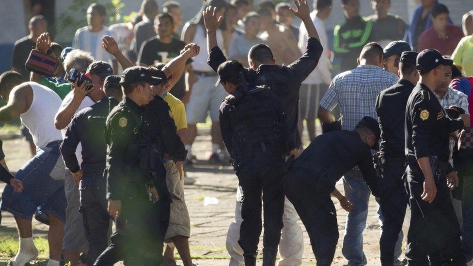 Police frisk prison inmates as authorities retake control of the Granja de Rehabilitacion Canada, in Escuintla, Guatemala (Nov. 30, 2015)