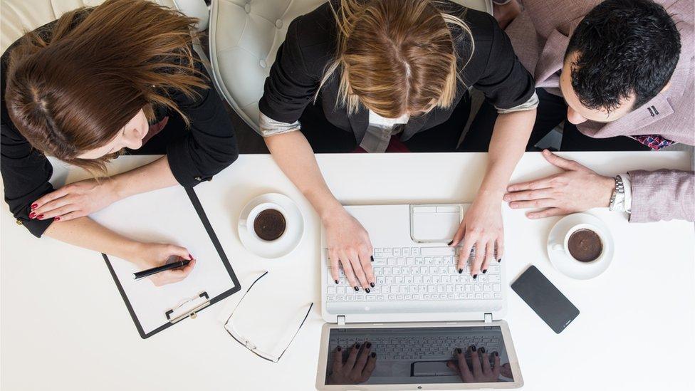 Young employees at a desk