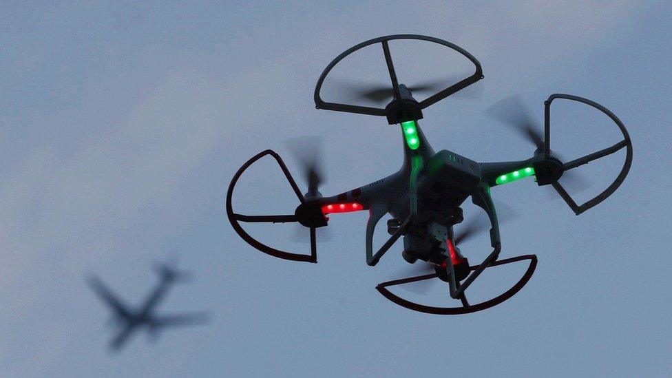 Drone with aeroplane in background