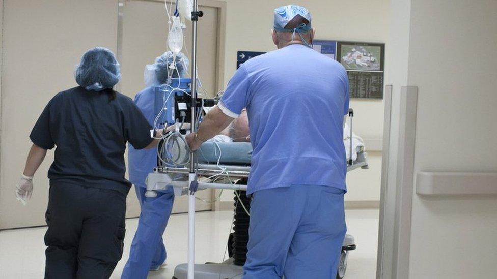 Hospital staff with a patient on a trolley