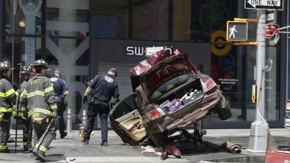 Emergency workers at the scene of the Times Square crash in New York.