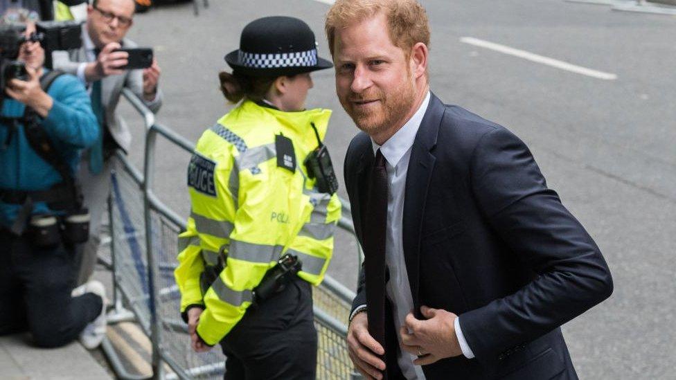 Prince Harry, next to police officer