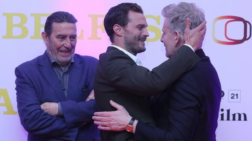 Jamie Dornan greets Patrick Kielty with Ciaran Hinds looking on