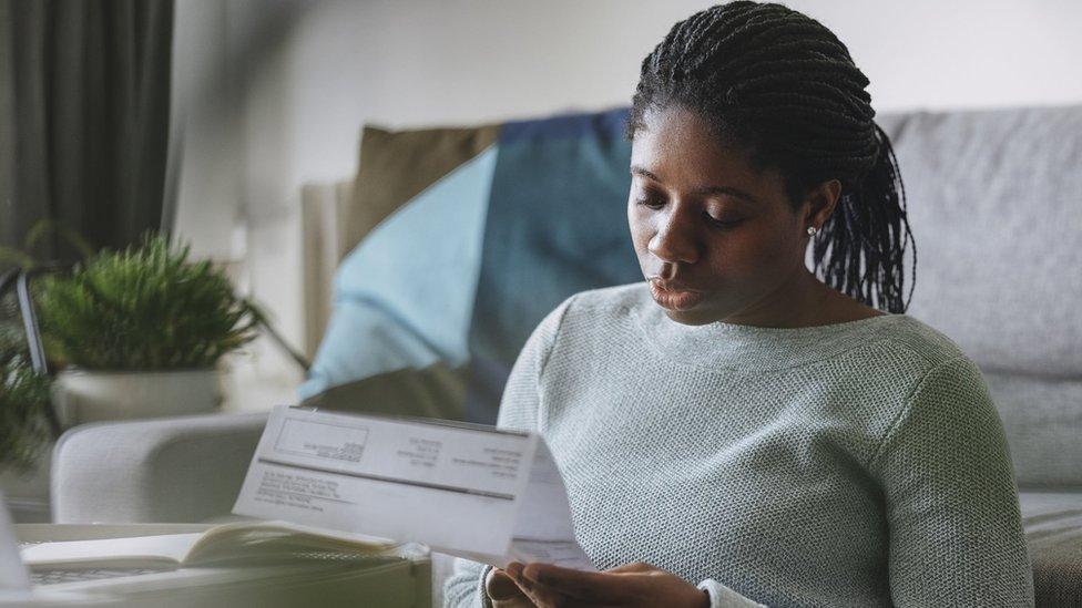 Young woman reading energy bill