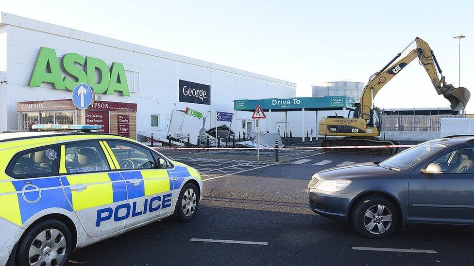 A large digger in the carpark of Asda in Antrim