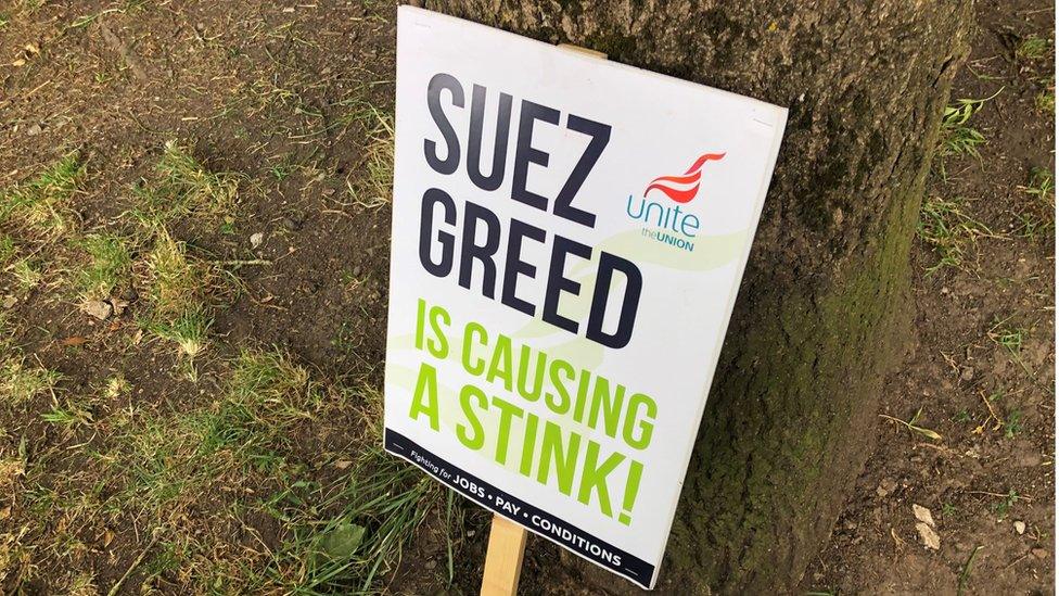 A placard saying 'Suez Greed Is Causing A Stink'