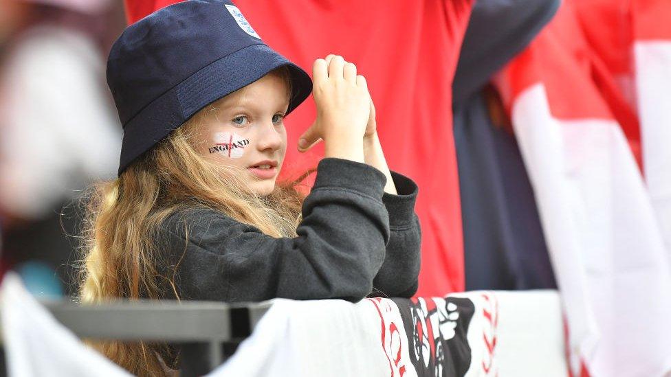 A young girl watches on during England v Sweden at Euro2022.