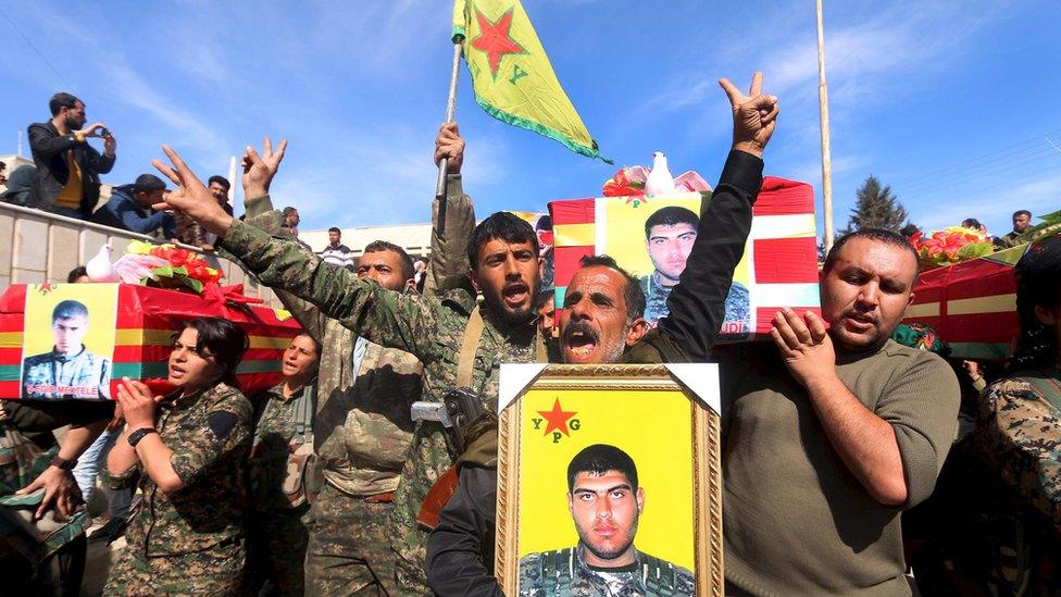 Fighters from the Syrian Kurdish Popular Protection Units (YPG) carry the coffins of comrades killed by Islamic State militants, at Ras al-Ain, Syria (2 March 2016)