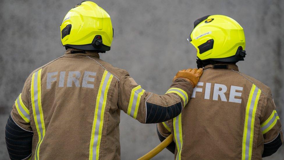 two members of the fire brigade, taken from behind