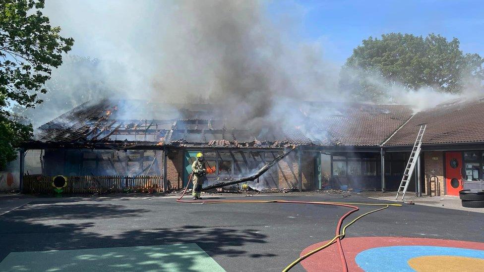 A building on fire with smoke billowing out