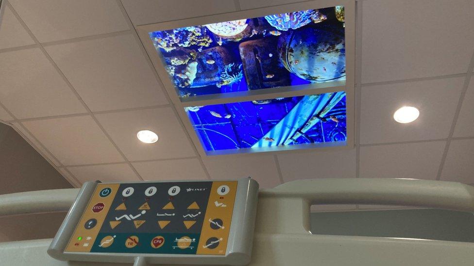 Dyson Cancer Centre - View from a bed looking up at a ceiling where fish are swimming in a tank